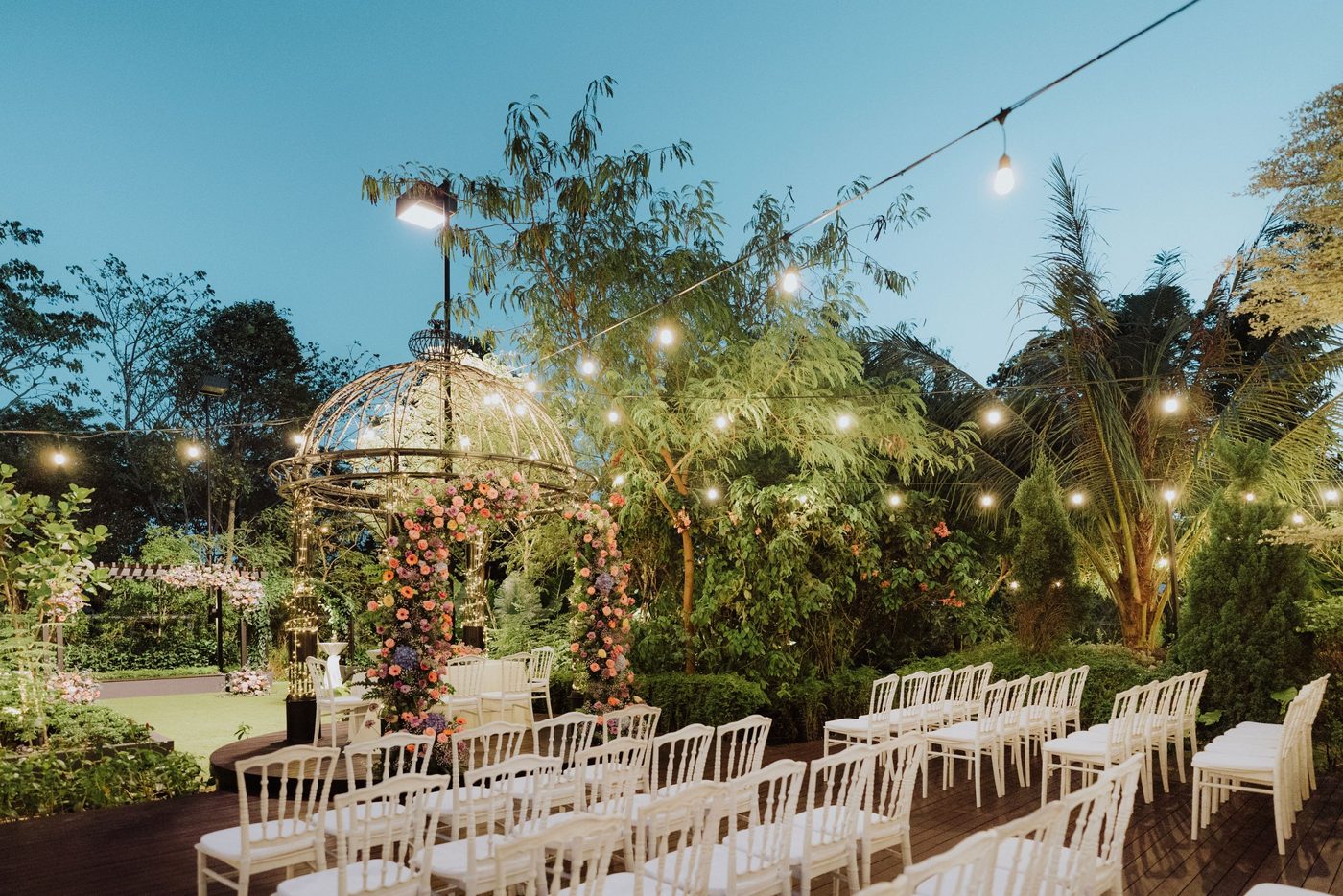 Evening garden wedding reception under fairy lights at The Summerhouse