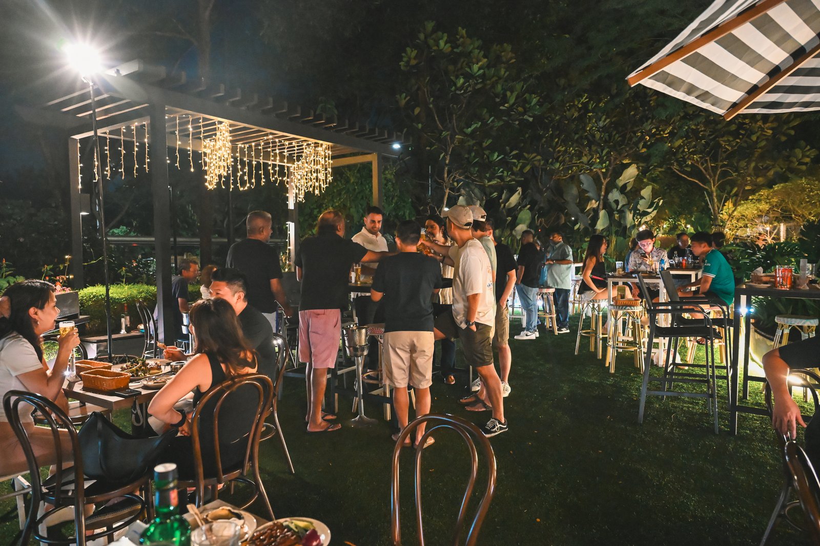 Evening crowd at the alfresco tables of Wildseed Bar, The Summerhouse