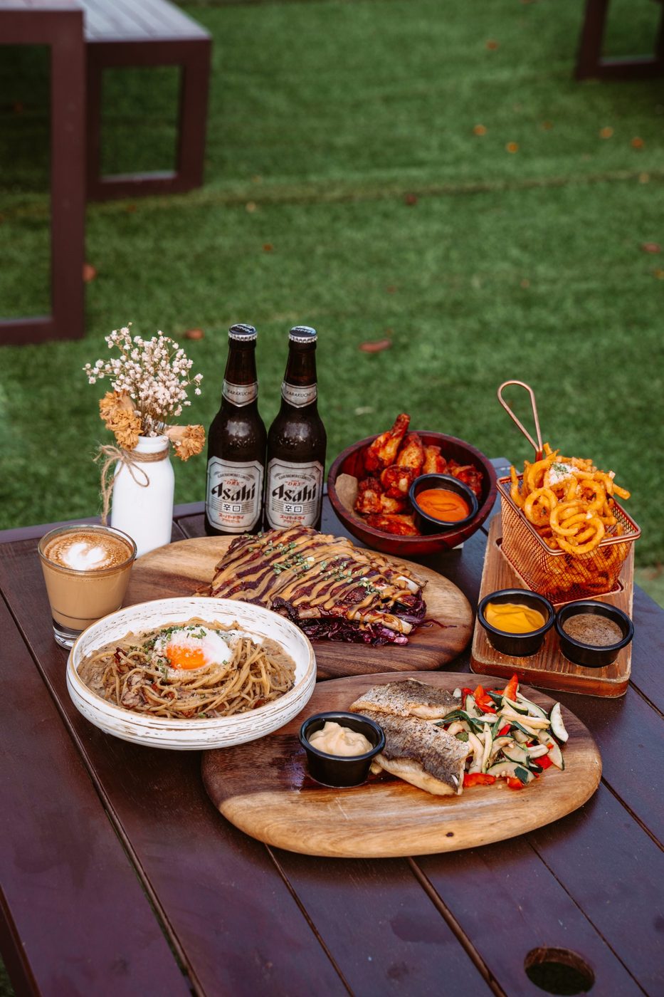 Grill platter and beers on the garden lawn at Wildseed Bar