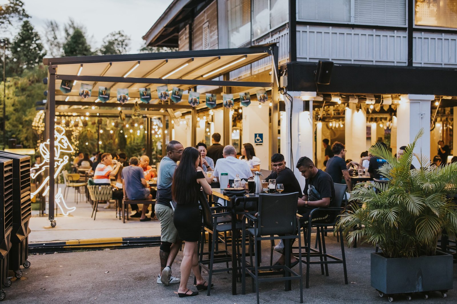 Wildseed Bar verandah lit up at night at The Summerhouse Seletar